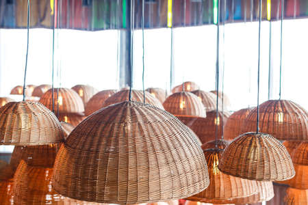 lamps in straw shades on the ceiling for decorationの写真素材