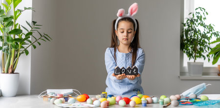 A girl showing her painted Easter Egg
