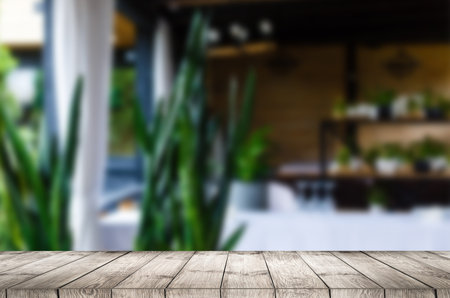 Wooden table and blur restaurant backgroundの写真素材