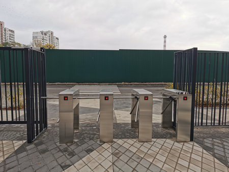 Closed entrance turnstile with access denied red sign. Security barrier