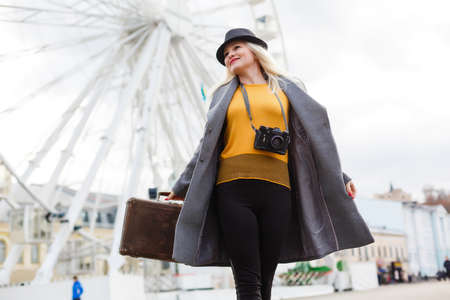 Stylish woman posing near ferris wheelの写真素材