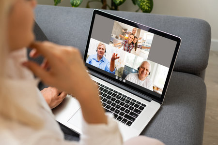 Back view of business woman talking to her colleagues about plan in video conference. Multiethnic...