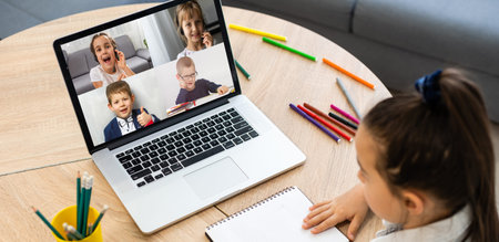 laptop with videoconference children classmates stands on the table
