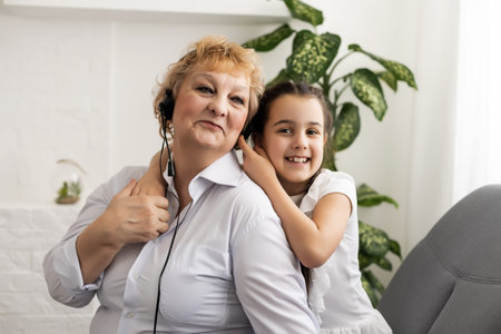 The elderly woman with the grand daughter, grandmother and granddaughter head shot