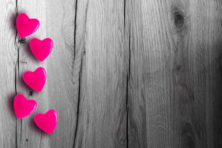 Valentines day background with red hearts on wooden planksの写真素材