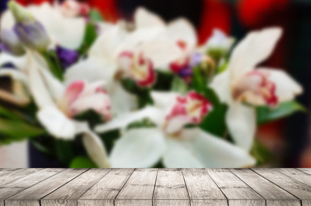 Empty top wooden table and flower blurred background. Can use for product displayの写真素材