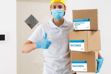 Man holds the vaccine box against white backgroundの写真素材