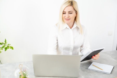 Businesswoman with Digital Tablet in Office, woman holding tabletの写真素材