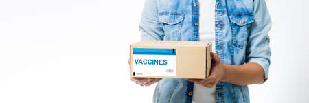 Man holds the vaccine box against white backgroundの写真素材