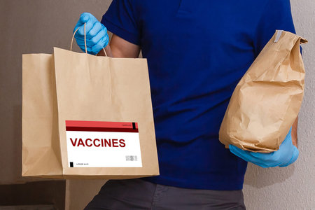 the man delivers the vaccine. Placing VACCINE label on the cardboard box