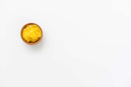 Golden honey in the wooden bowl with dipperの写真素材