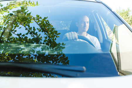 Portrait of an handsome guy driving his car