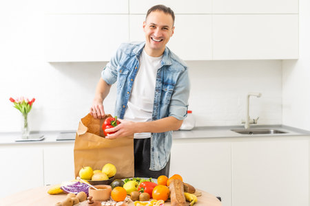 Young man eating a healthy salad, vegetables, healthy food.の写真素材