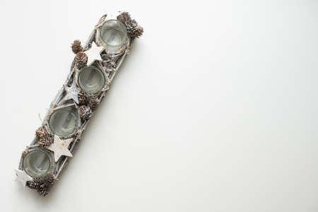 A glass candlestick. The candlestick is filled with dried cones.の写真素材