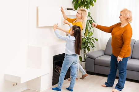 little girl mother and grandmother with Mockup photo canvasの写真素材