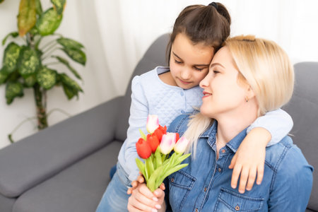 A loose baby tooth falls out in a little girl with an open mouthの写真素材