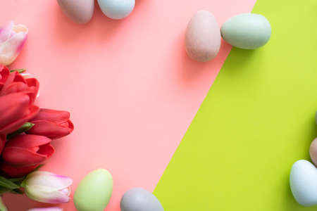 Easter banner with colorful eggs and tulip flowers on bright green background.の写真素材