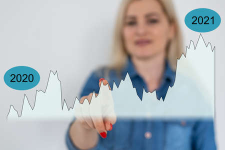 Concept of growth planning and business strategy. Woman holds and showing hologram graph and stock market statistics gain profits, good economy form digital screen, double exposure, collageの写真素材