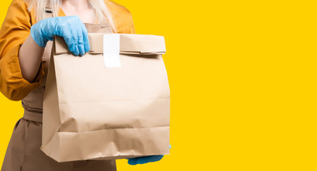 Young woman preparing takeaway organic food inside plastic free restaurant during virus outbreak...