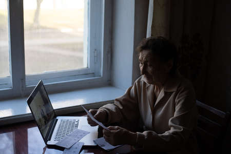 Pensioner read countless papers and is very focusedの写真素材
