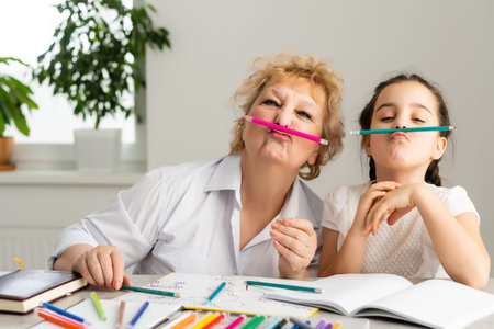 Grandmother with little girl doing homework