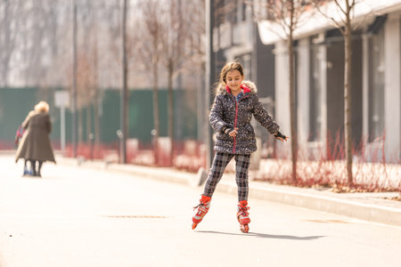 Cute little girl rollerblading. sports and entertainment.