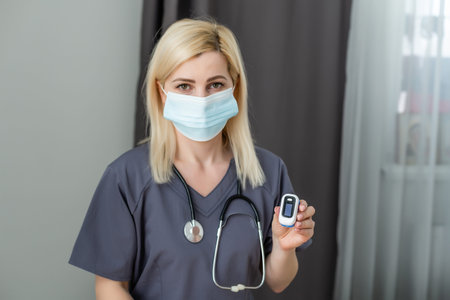 Doctor measuring patients hemoglobin level. Showing usage of finger pulse oximeter