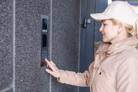 Stunning face. Intercom, interphone. Young cheerful fashionable woman during walking on street. Female fashion beauty and advertisement conceptの写真素材