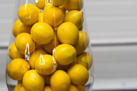 lemons in a glass vase on a white backgroundの写真素材