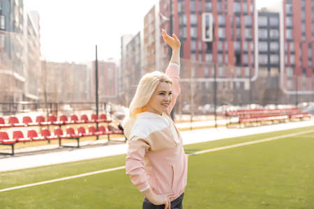 sexy fitness woman in sportswear. athletic lady warming up on stadium running track. female athlete do sport workout. trainer or coach training. perfect body shape. healthy and sportyの写真素材