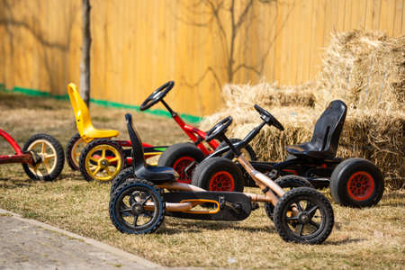 Childrens bicycle parked by the bench in the parkの写真素材