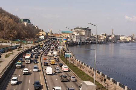 Kyiv, Ukraine- April 1, 2021: Automobile collapse at the highway along Dnipro River. Traffic jam with rows of cars on motorway in the week-end day in Kyiv. Concept of traffic jams in the big city.のeditorial素材