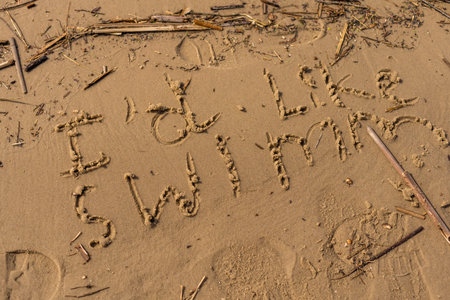 A lettering drawing on sand by the river