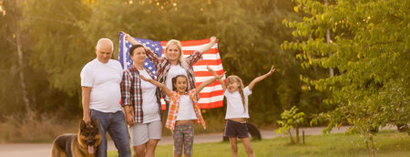 Family Posing Outdoors With American Flagの写真素材