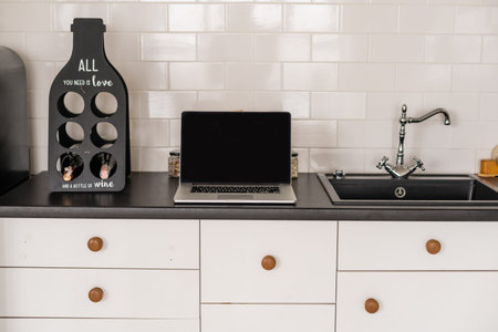 Modern and stylish laptop on a table in the kitchen