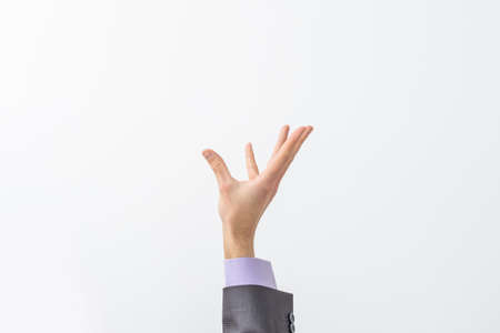 Mans hand in suit begs to something isolated on white background. Palm up, close up. High resolution productの写真素材