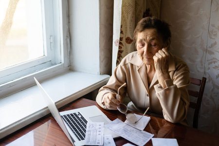 Retired woman calculating her domestic bills