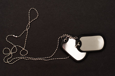 dog tag, army chains, army badge on the dark background.