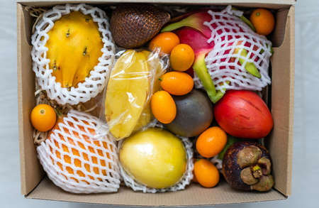 Variety of exotic fruits in a wooden crateの写真素材