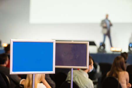 pointer to conference. Audience at the conference hall. Business and Entrepreneurship concept. Lens focus on people in audience from rear.の写真素材