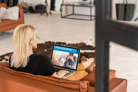 Young woman is using laptop for remote conversation with friend. People having fun staying at home