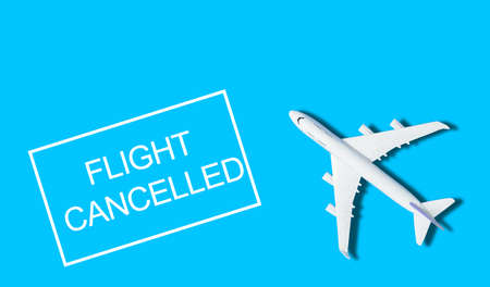 Flat lay design of travel concept with plane on blue and yellow background with copy spaceの写真素材