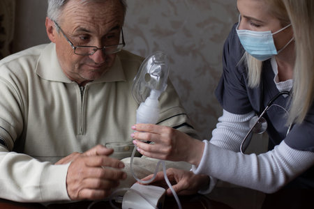 Elderly man on oxygen mask, nebulizer