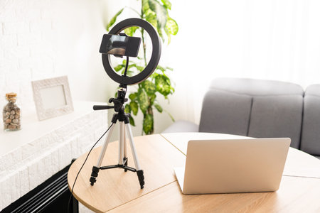 Creative workspace of a blogger. White laptop computer on wooden table in loft style office with...