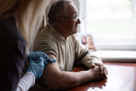 Happy senior man being vaccinatedの写真素材