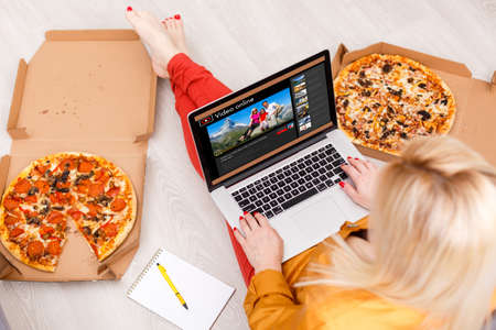 Happy woman planning vacations on line searching information in a laptop in a resort or hotel.の写真素材