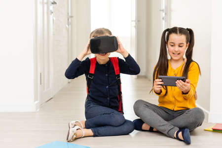 Two girls in headset virtual vr reality. Childhood kids education lifestyle conceptの写真素材