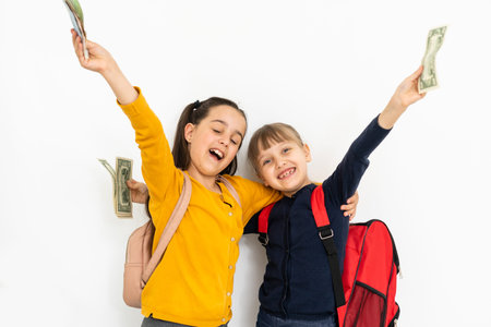 two little girls with money dollar and euroの写真素材