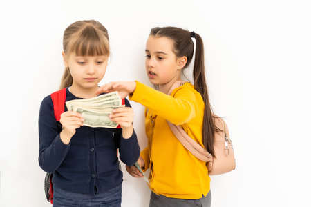 two little girls with money dollar. Isolated.の写真素材