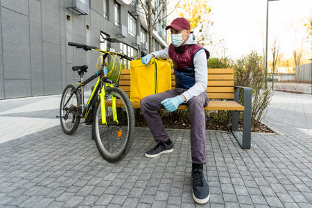 Young delivery man with yellow backpack takeaway concept